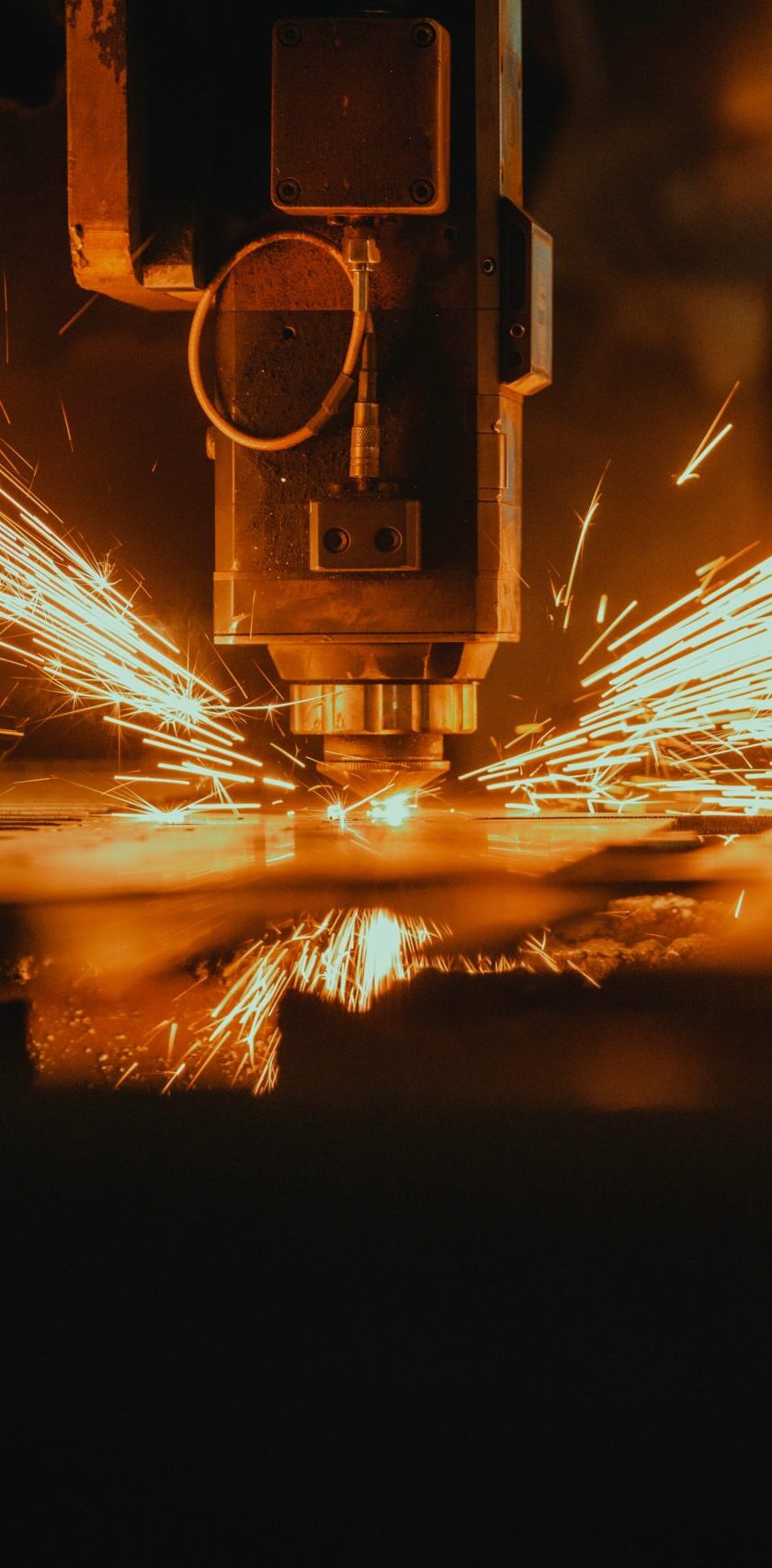 CNC-Fräsmaschine bei der Arbeit, Funken sprühen während der präzisen Bearbeitung eines Werkstücks.